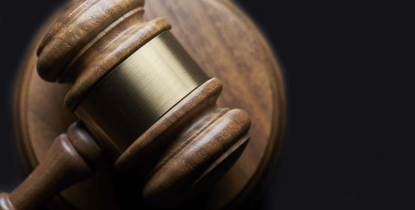 A brown and gold wooden gavel